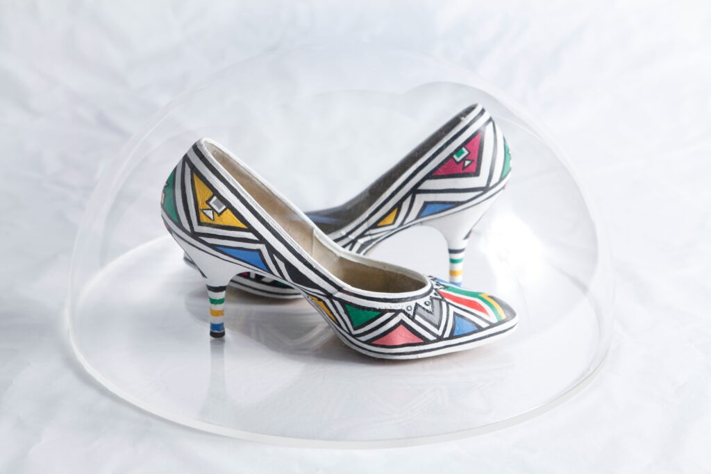 A Retrospective Unveiling: A Life of Artistic Brilliance 7 Esther Mahlangu Suid Afrika Vorentoe (South Africa Ahead) Paintd shoes