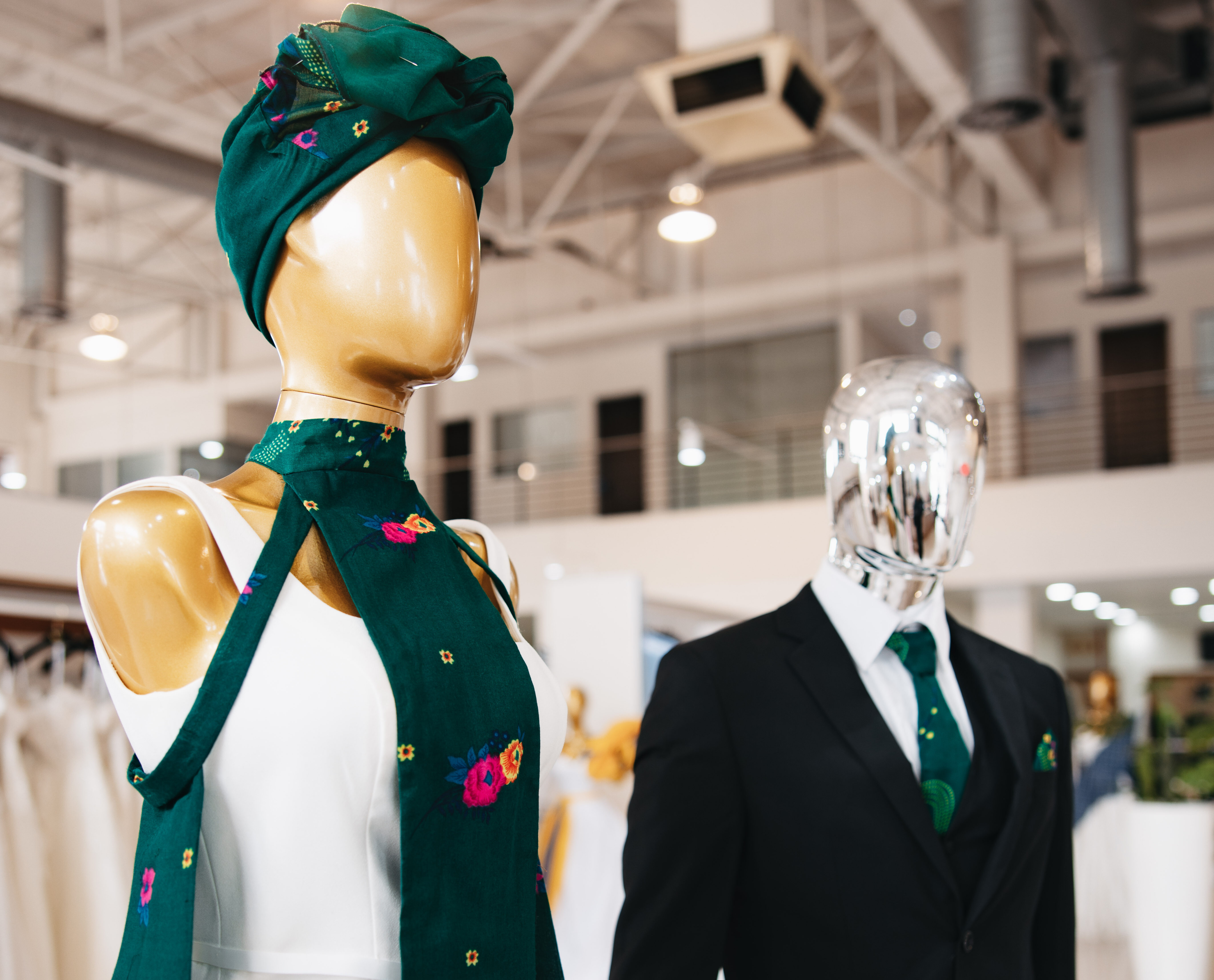 Male and female mannequins displaying Threads of Heritage accessories on bridalwear