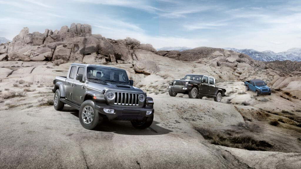 Jeep embarks on South Africa’s inaugural Easter Jeep Safari 2 Jeep Gladiator off-road trucks navigating rocky desert terrain with large boulders and mountain scenery in the background