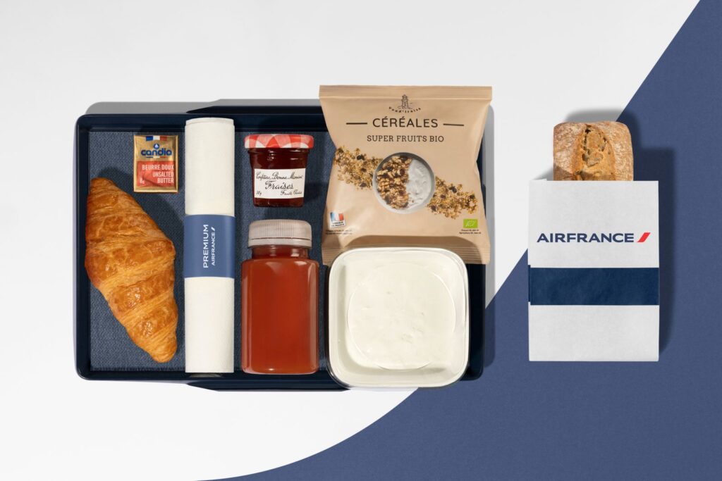 Air France premium breakfast tray with croissant, juice, yoghurt, granola and French butter on inflight service