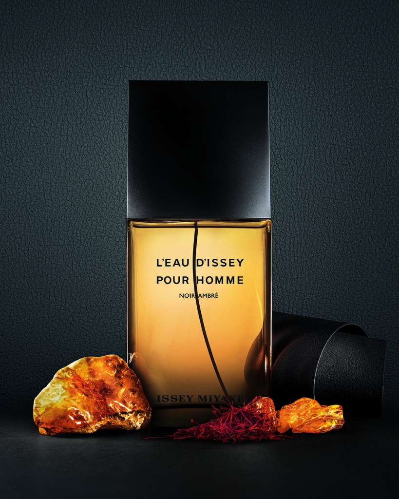 A curated selection of luxury men’s fragrance bottles including Issey Miyake L’Eau d’Issey Pour Homme Noir Ambre, Zadig & Voltaire This Is Him! Eau de Toilette, and Narciso Rodriguez for Him Bleu Noir Parfum, styled as a sophisticated edit of modern masculine scents featuring warm amber, woody, spicy, and musk profiles.