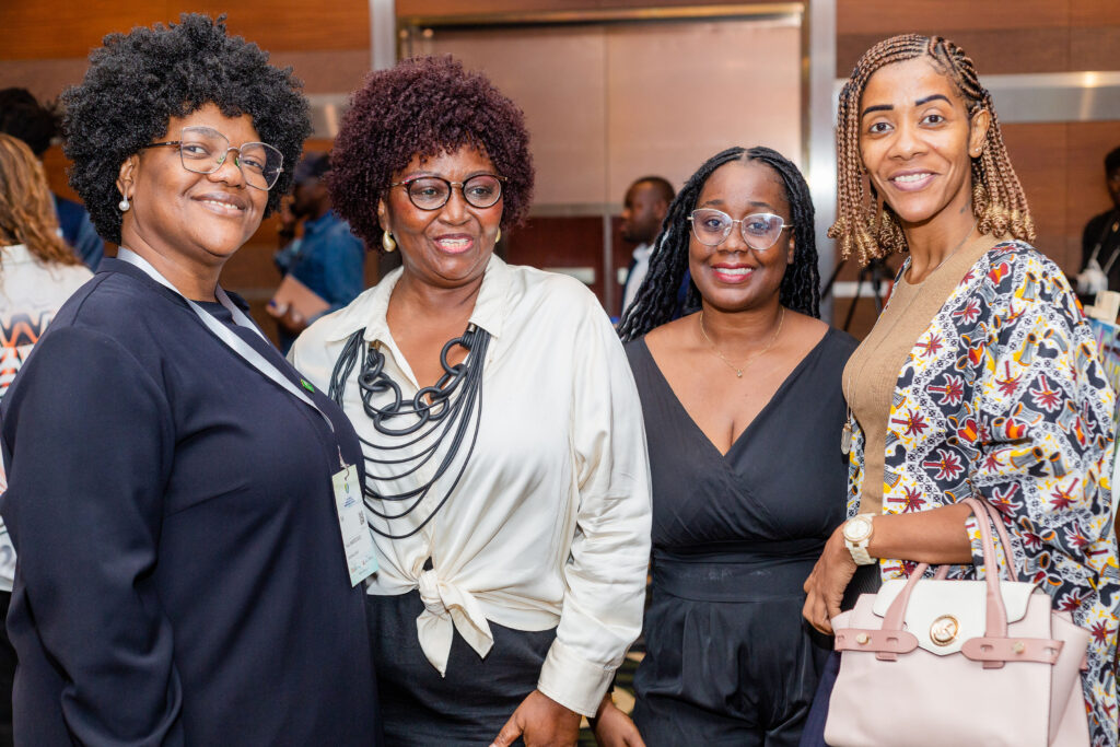 Four women smiling towards the camera