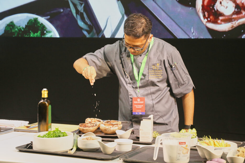 A chef plating a dish during a live cooking demonstration at the IMBO Theatre of Taste, The Good Life Show Johannesburg
