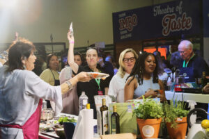 A chef plating a dish during a live cooking demonstration at the IMBO Theatre of Taste, The Good Life Show Johannesburg