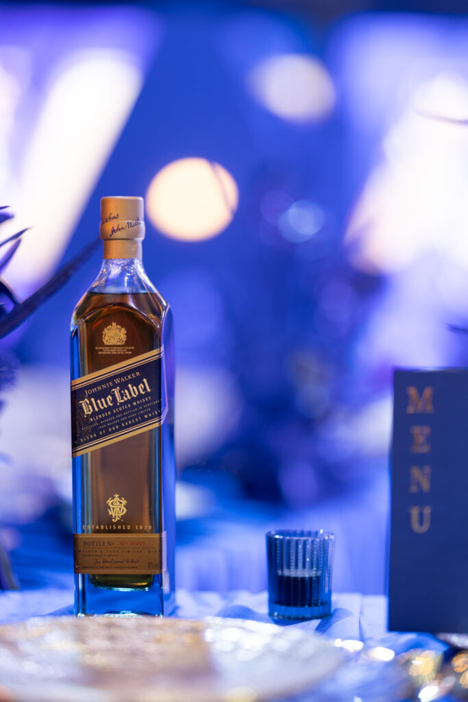 A Symphony in Every Pour: The Rare Composition of Johnnie Walker Blue Label 3 Johnnie Walker Blue Label being poured into a crystal tumbler in a low lit private dining setting